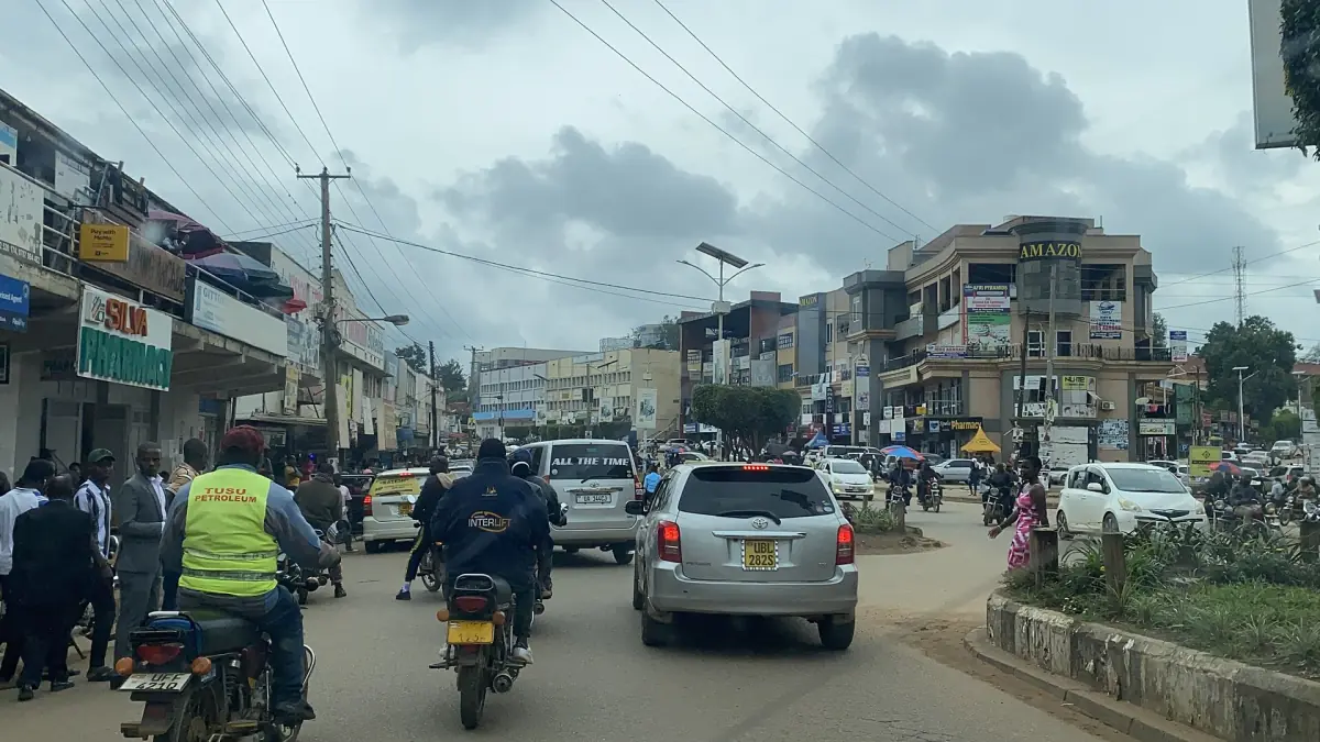 Busy high street in Mbarara with motorbike taxis and cars